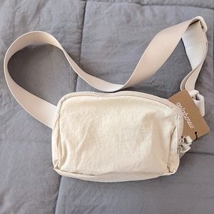 Tan unisex belt bag. NWT soft nylon with durable adjustable belt.